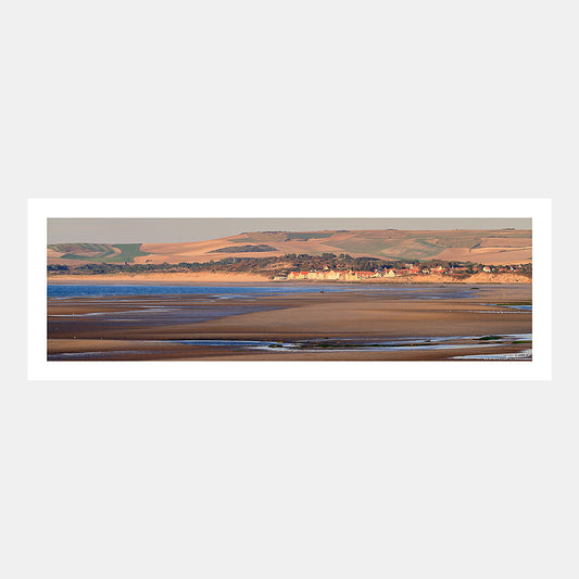 Photographie panoramique du front de mer de Wissant avec la plage à marée basse et les dunes dans le soleil couchant, Côte d'Opale, Pas-de-Calais, Hauts-de-France, France.